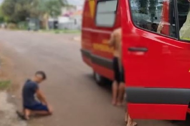 Criança reza de joelhos após irmão ser atropelado